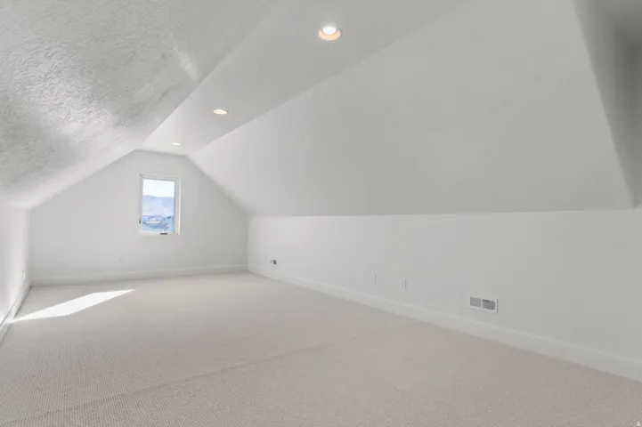 Bonus room featuring carpet, recessed lighting, and a textured ceiling