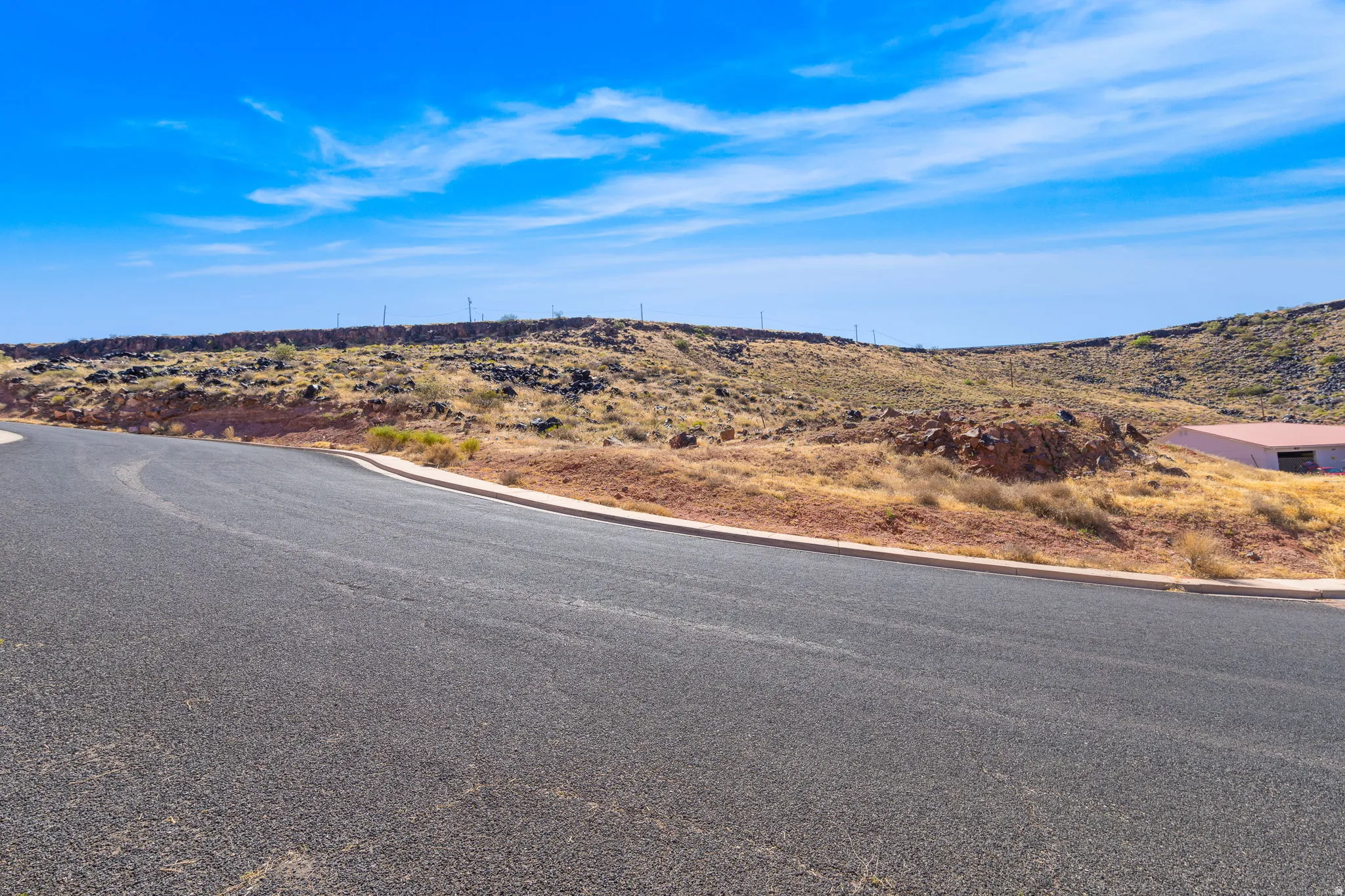 View of asphalt street with curbs