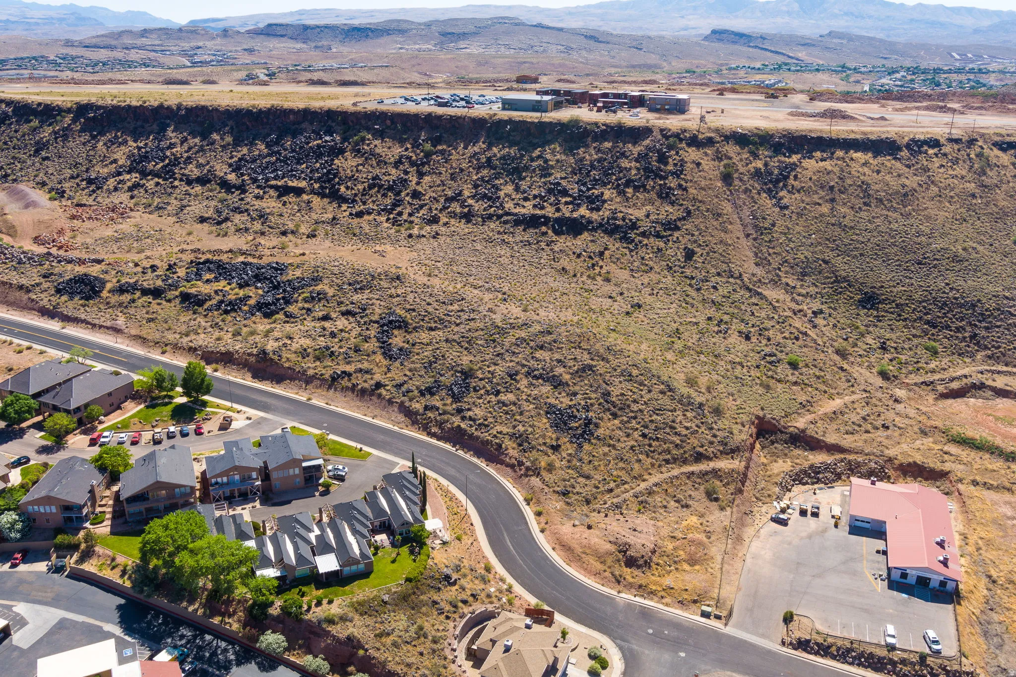 Aerial view of property's location with a mountain backdrop and a desert landscape