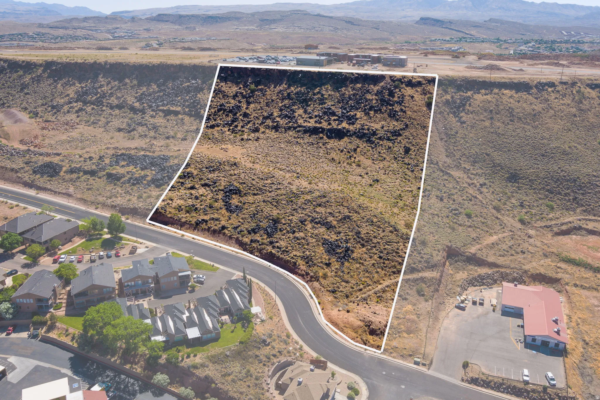Aerial view of property's location featuring a mountain backdrop and property boundaries highlighted