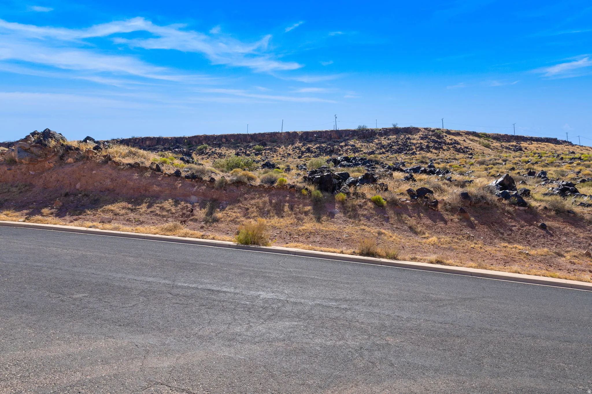 View of asphalt street with curbs
