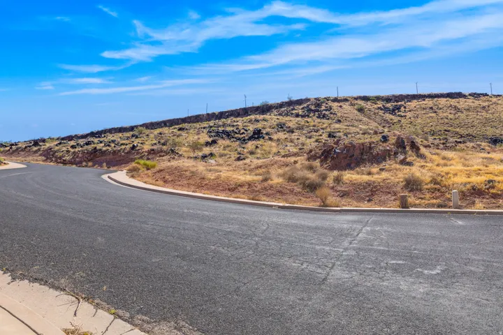 View of asphalt road featuring curbs