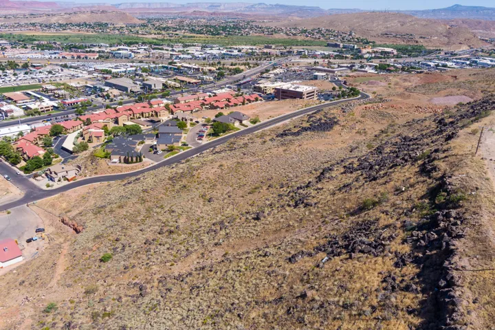 Aerial view of property and surrounding area with a mountainous background