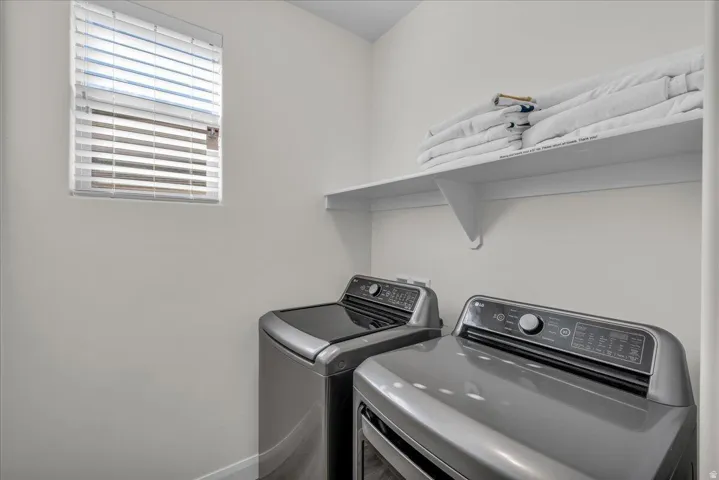 Laundry area featuring baseboards and separate washer and dryer