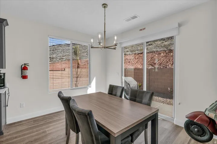Dining space featuring light wood-type flooring and suspended lighting