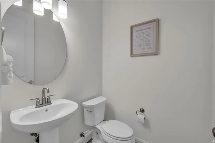 Bathroom with toilet and baseboards
