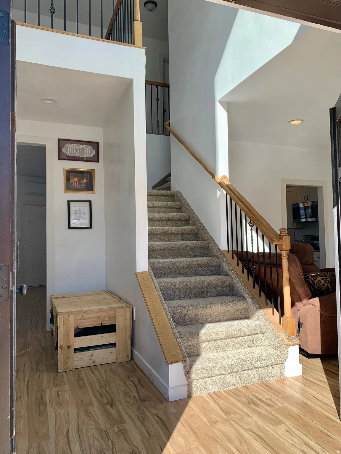 Stairway featuring wood finished floors and recessed lighting