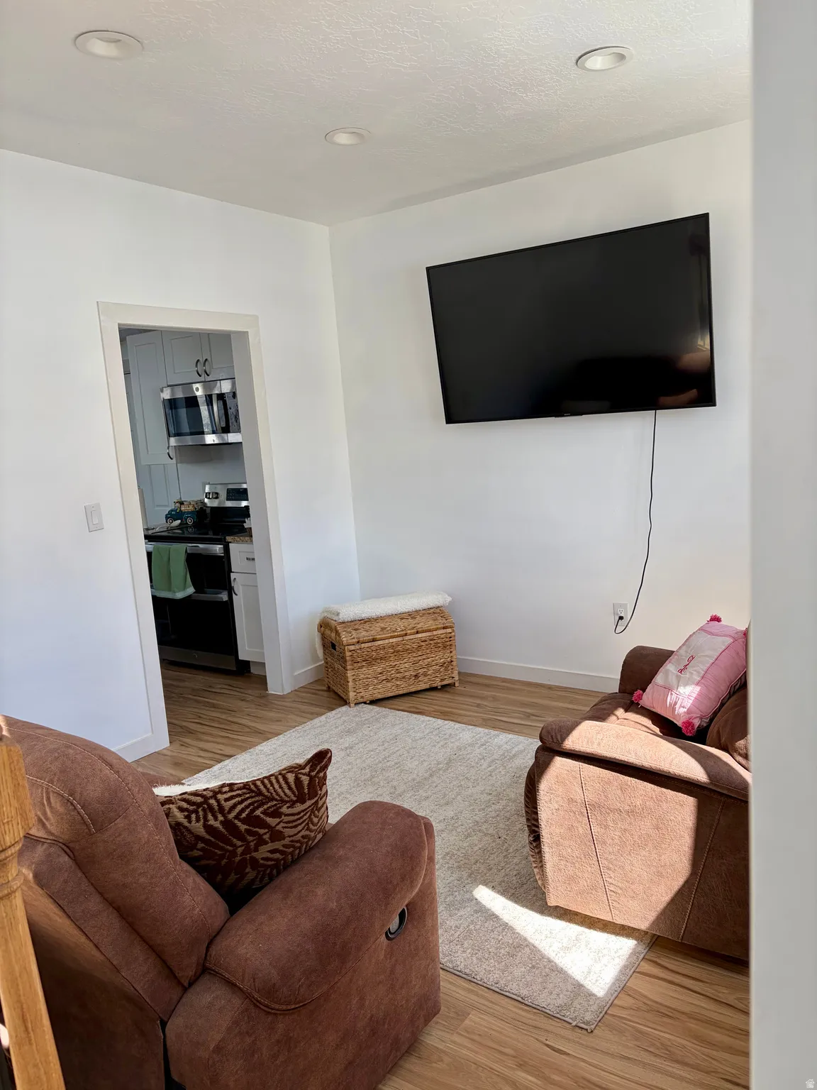 Living room featuring light wood-style floors and recessed lighting