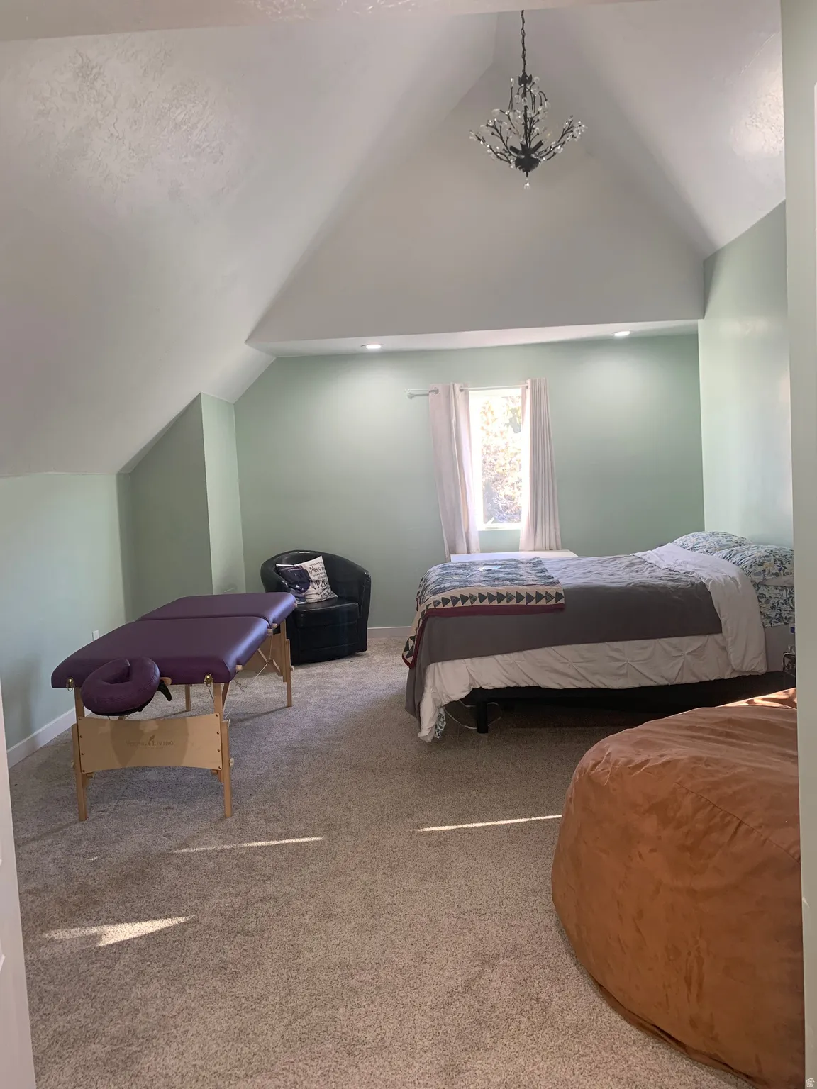Carpeted bedroom with baseboards and hanging lights
