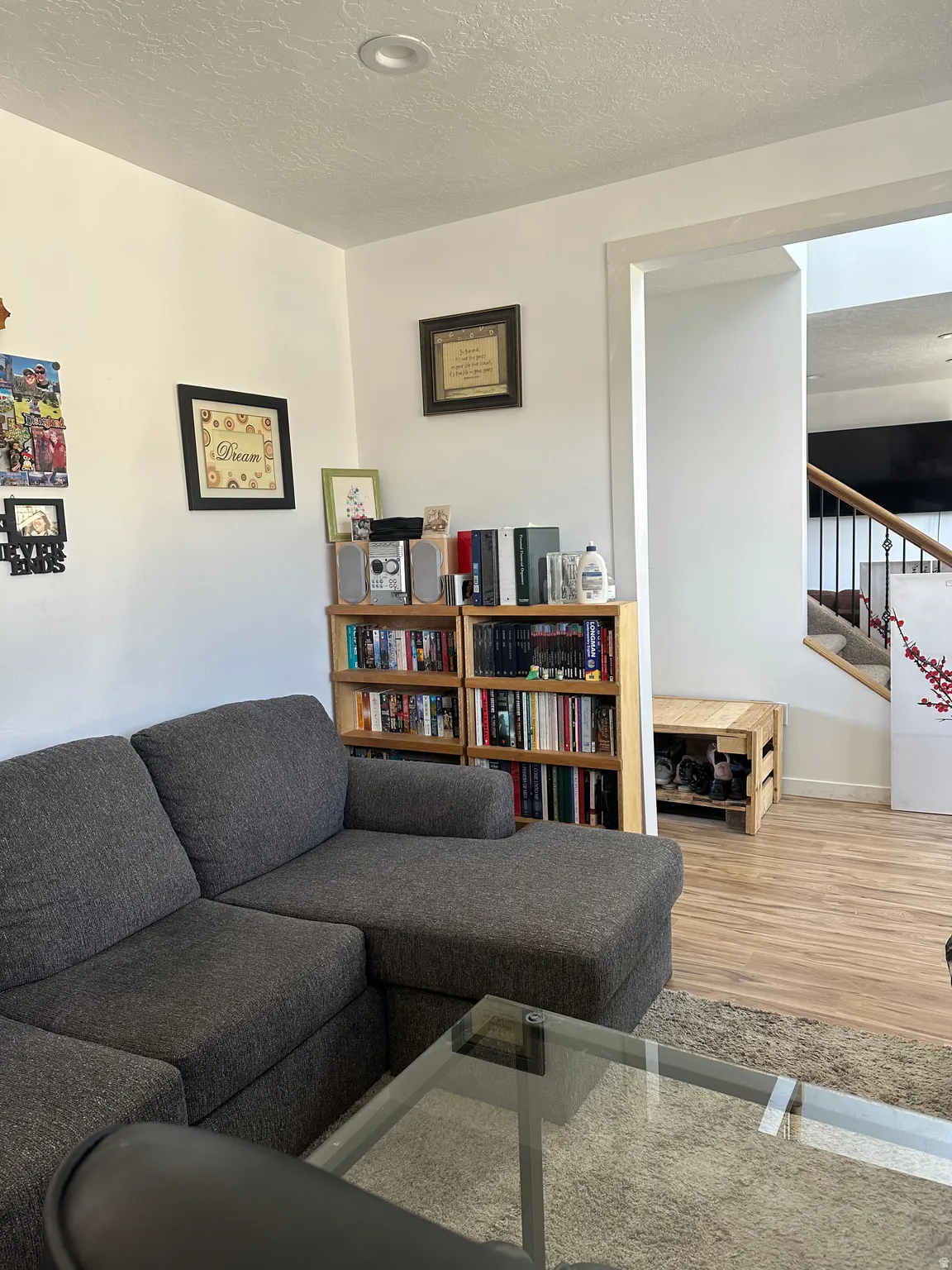 Living area with a textured ceiling and stairway