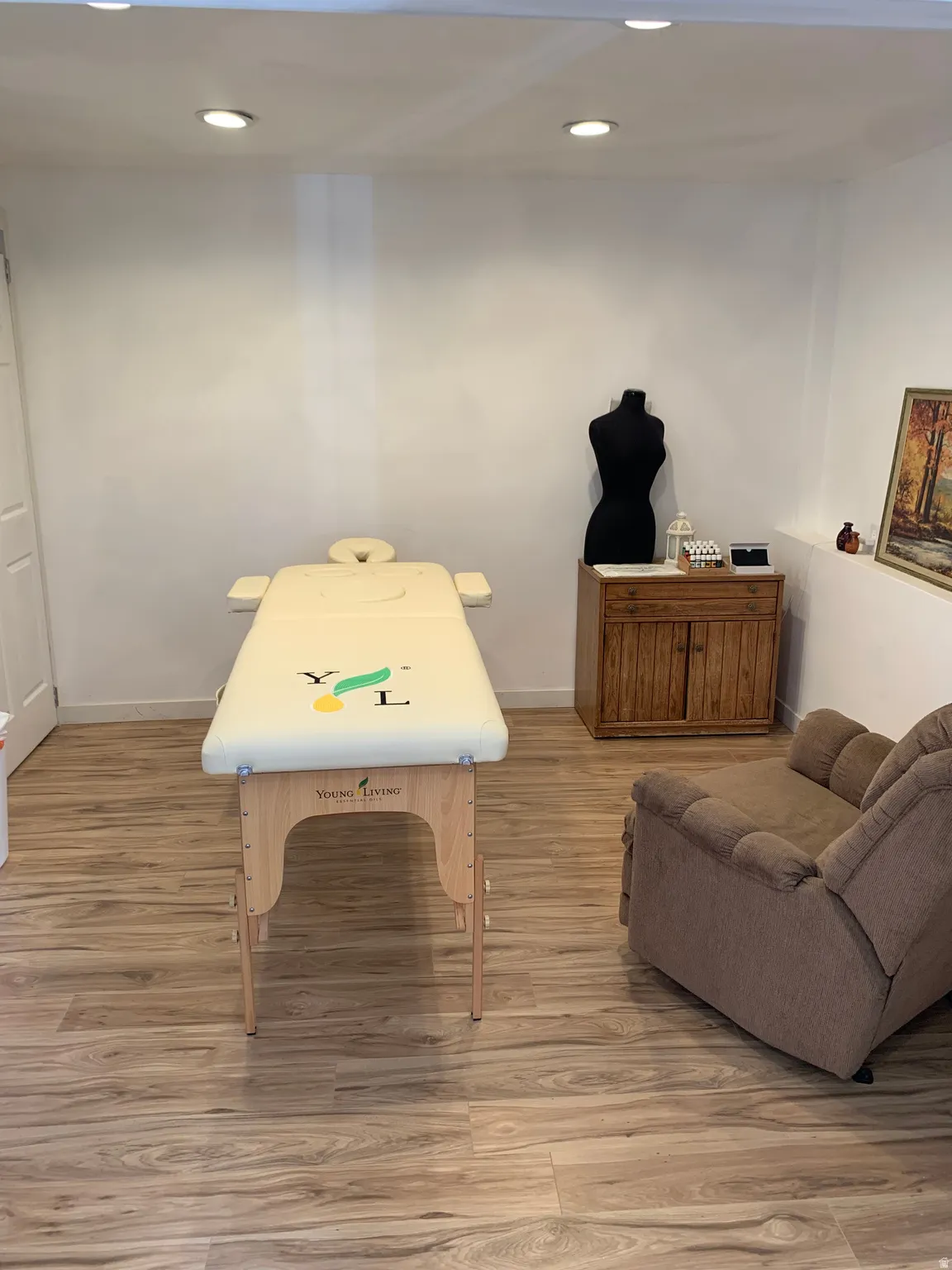 Recreation room with light wood-style flooring and recessed lighting