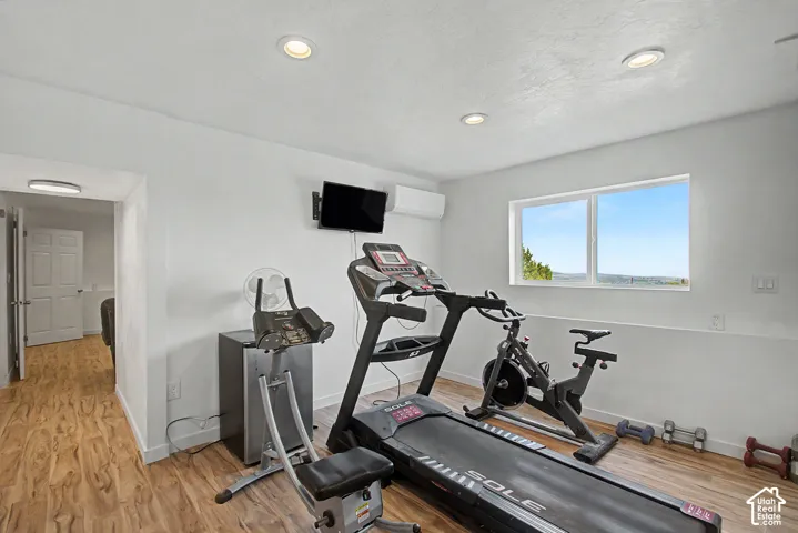 Versatile flex space featuring wood-finish flooring, recessed lighting, and a large window offering expansive outdoor scenery