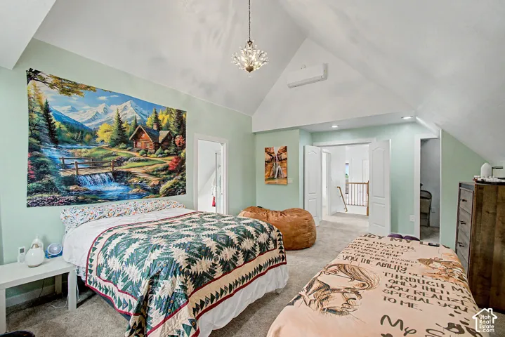 Vaulted ceiling room featuring light green walls, a crystal chandelier, recessed lighting, and a ductless mini-split system