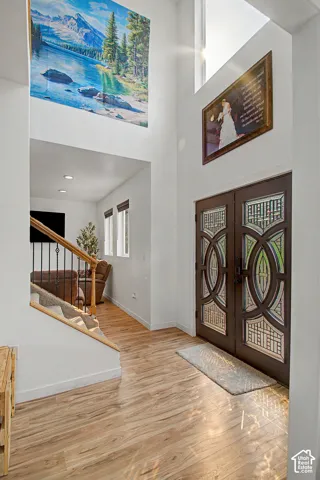 Grand entryway featuring double doors with decorative glass panels