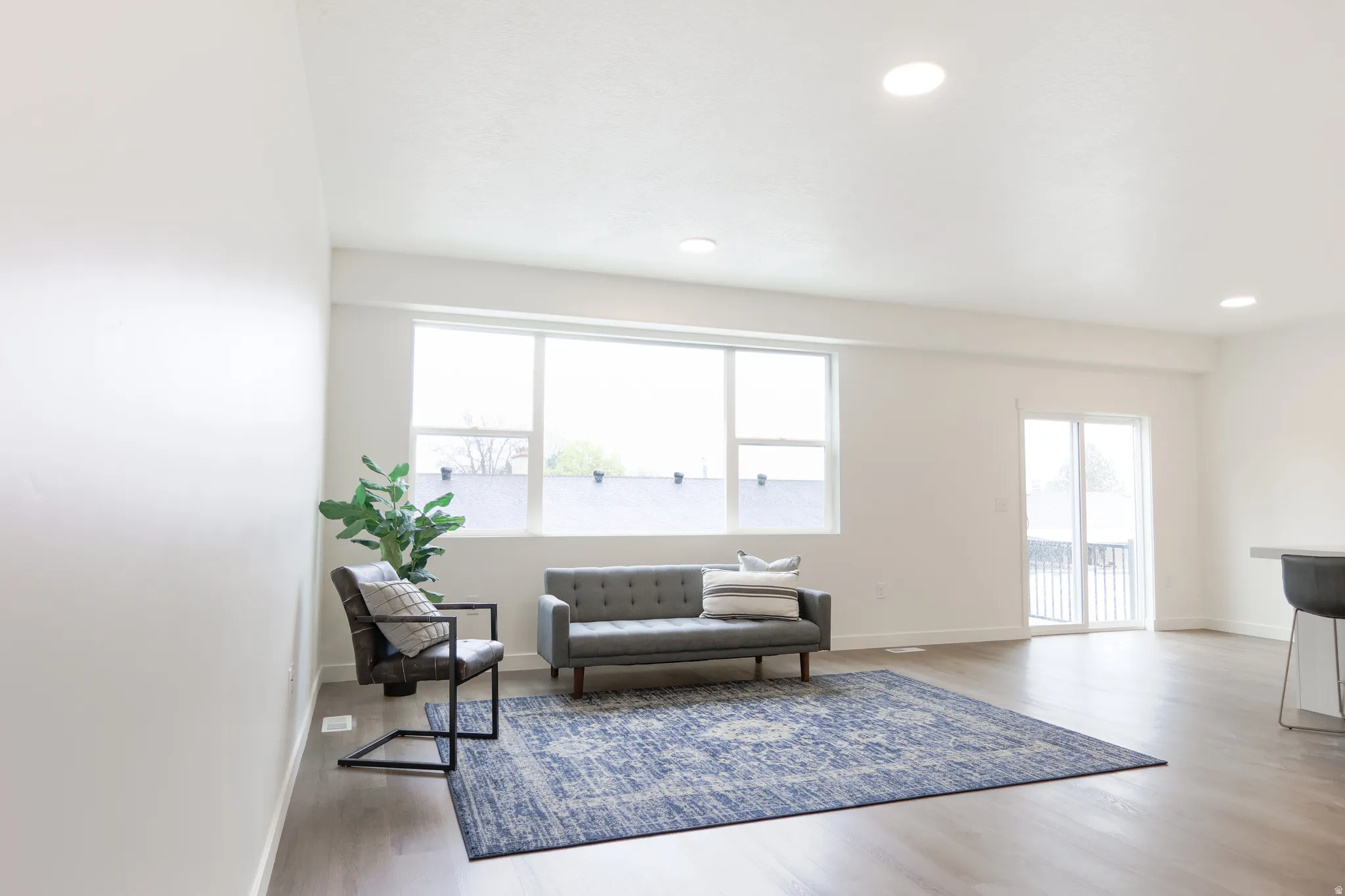 Living area featuring light wood finished floors and recessed lighting