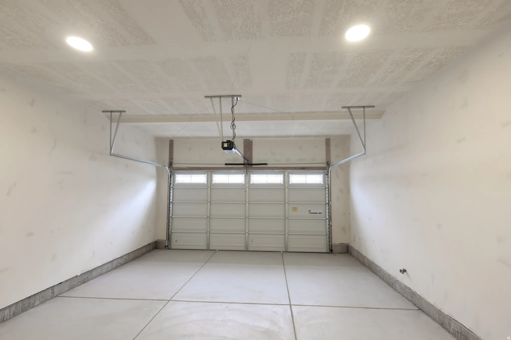 Garage with recessed lighting and baseboards