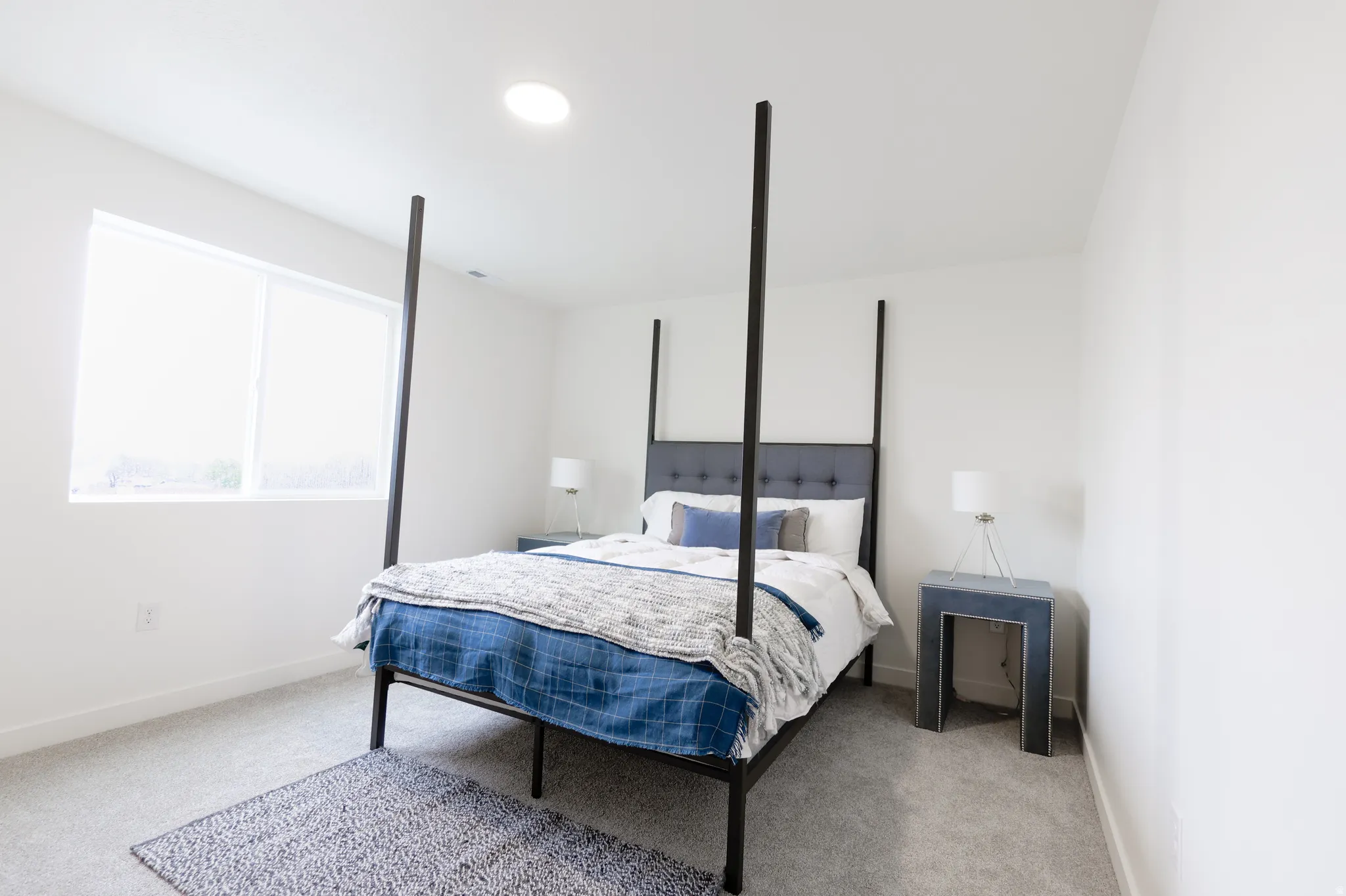 Bedroom with light carpet and baseboards