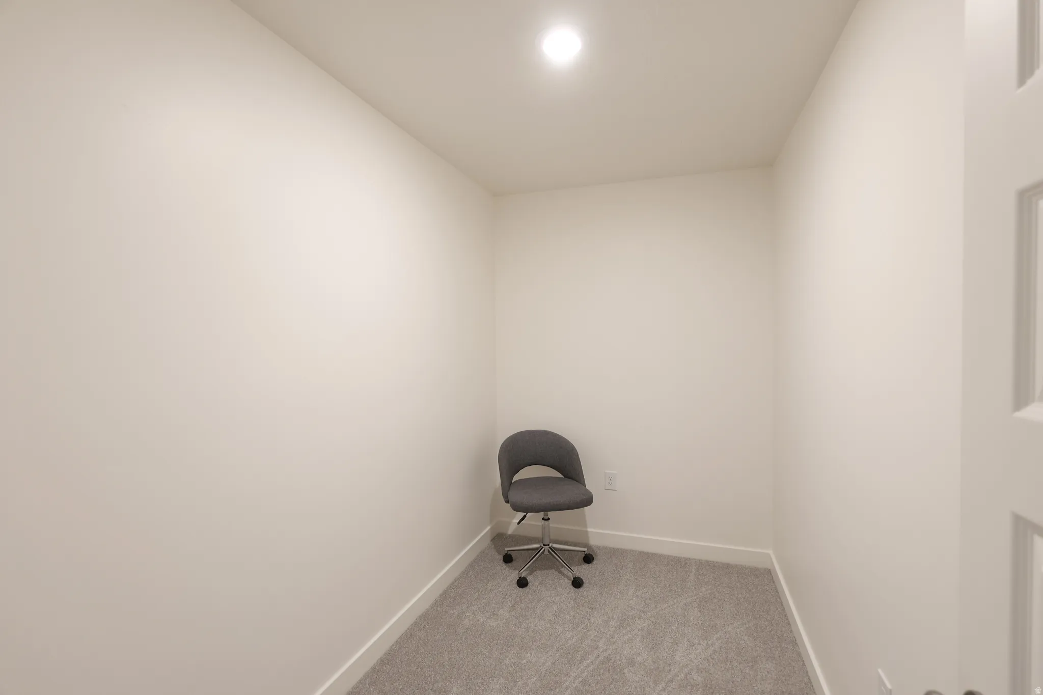Misc room with baseboards and light carpet