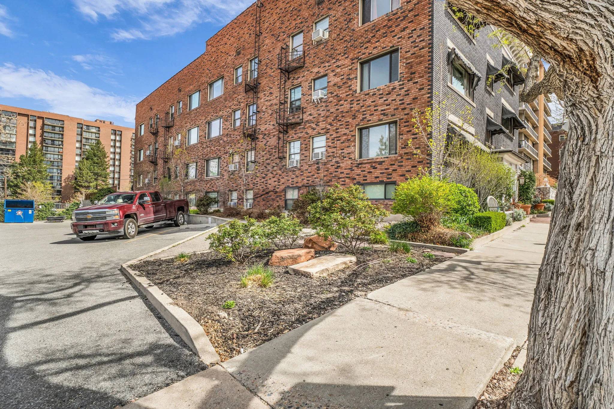 View of apartment building / complex with uncovered parking
