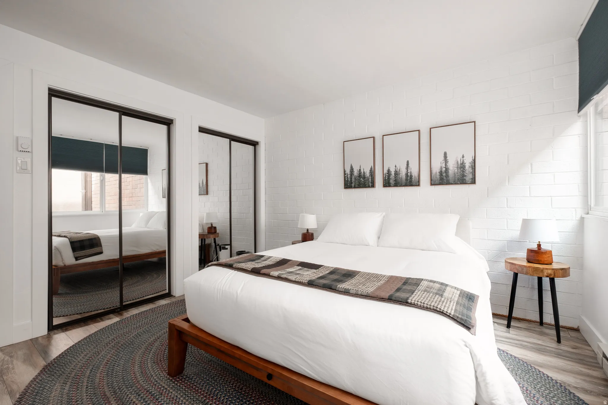 Bedroom with two closets and wood finished floors