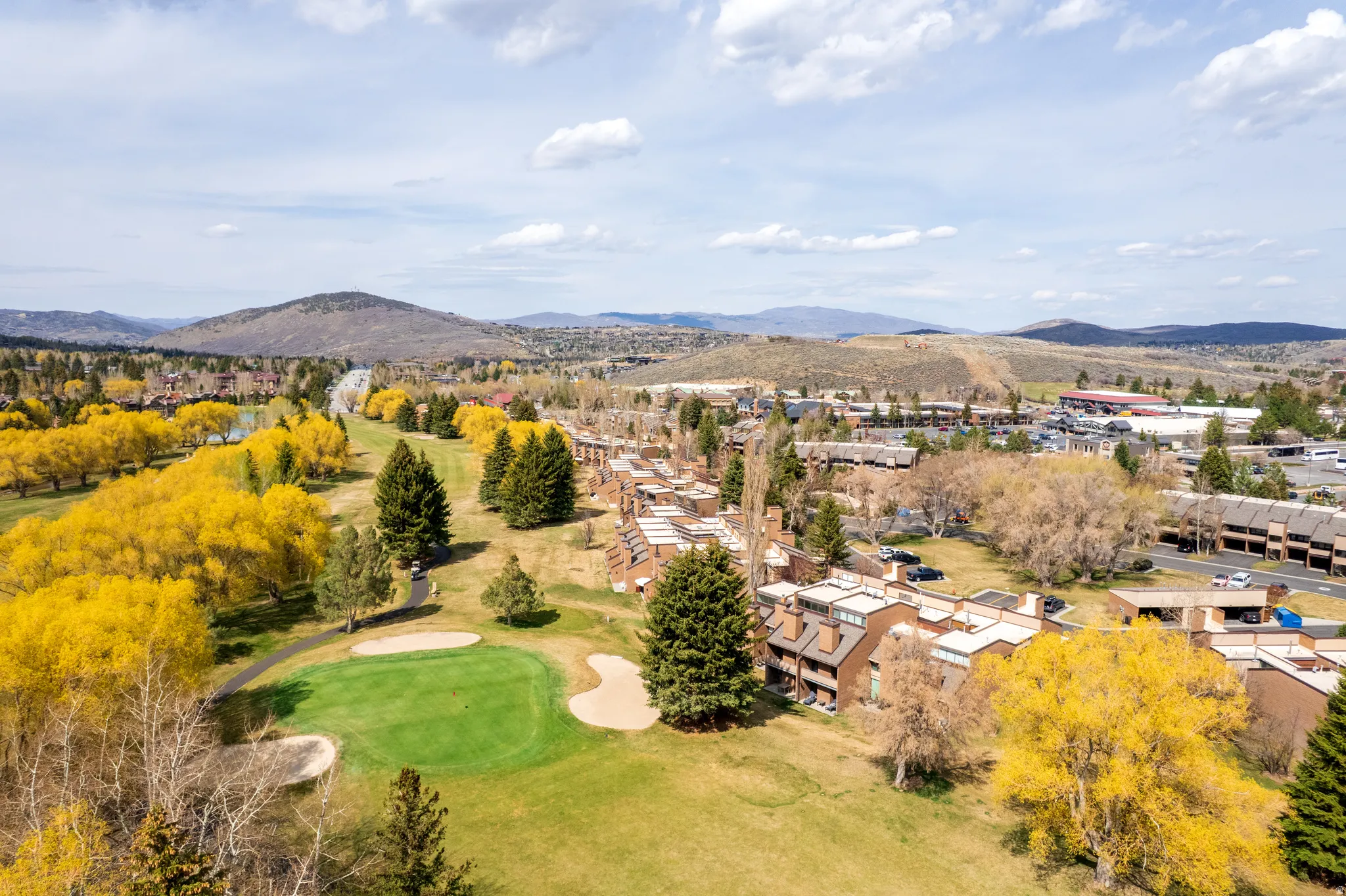 Aerial view of a mountainous background and a golf course