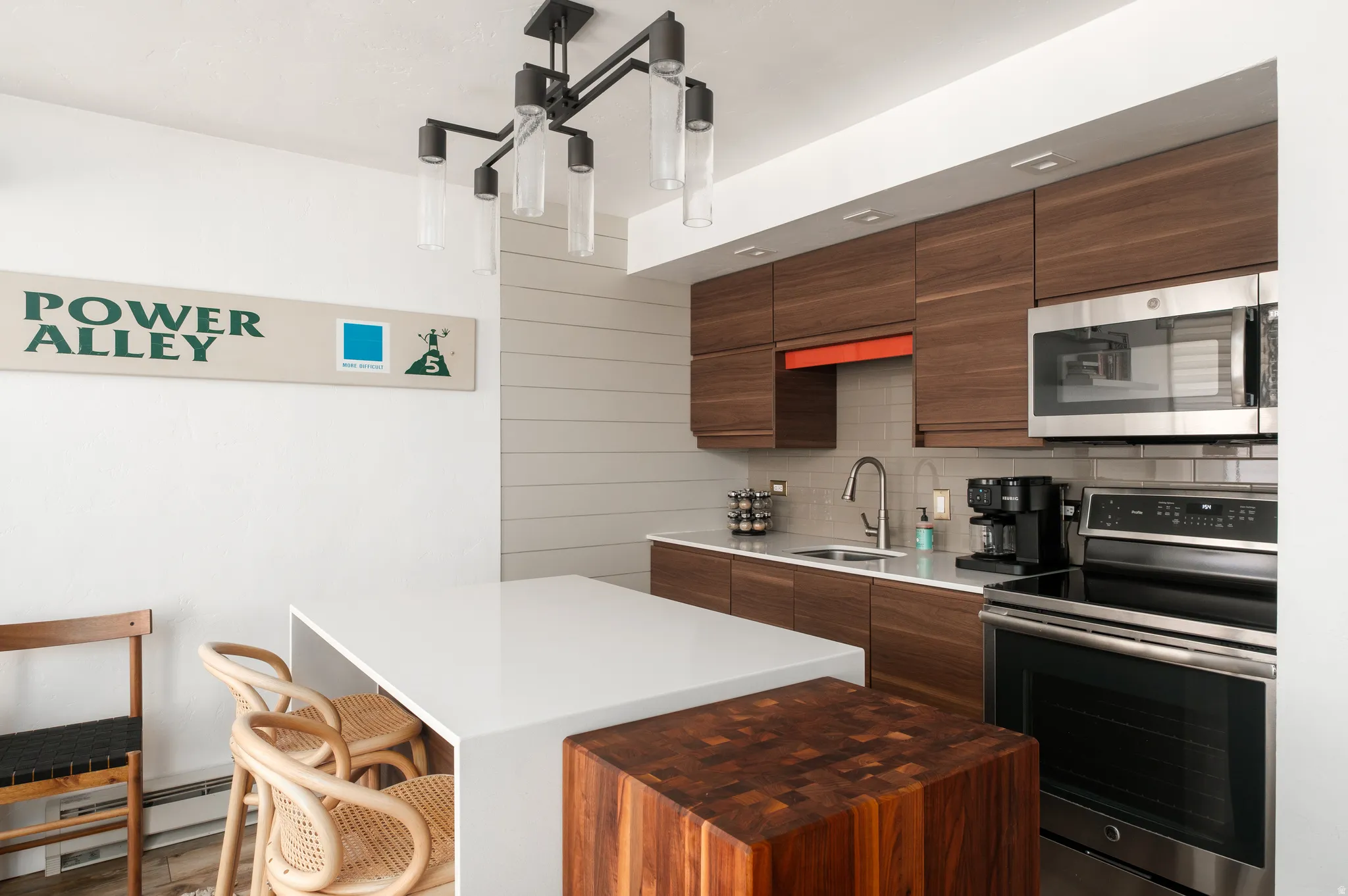 Kitchen with stainless steel appliances, modern cabinets, a kitchen bar, and a kitchen island