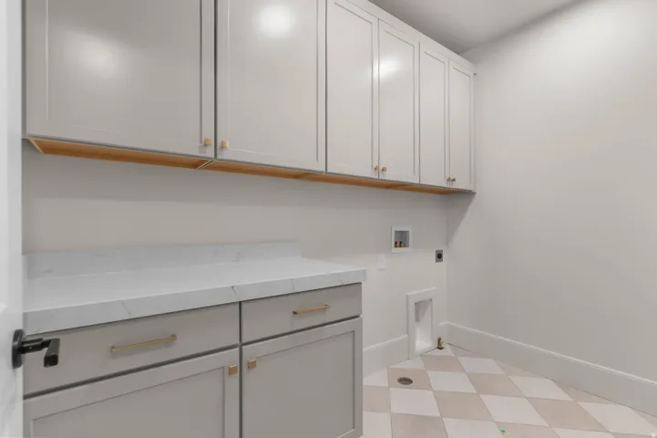 Laundry area featuring washer hookup, electric dryer hookup, and cabinet space