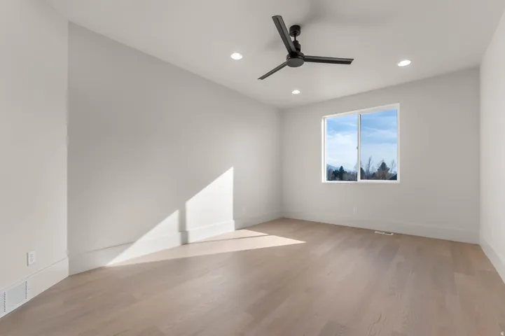 Spare room with light wood-style floors, recessed lighting, and ceiling fan