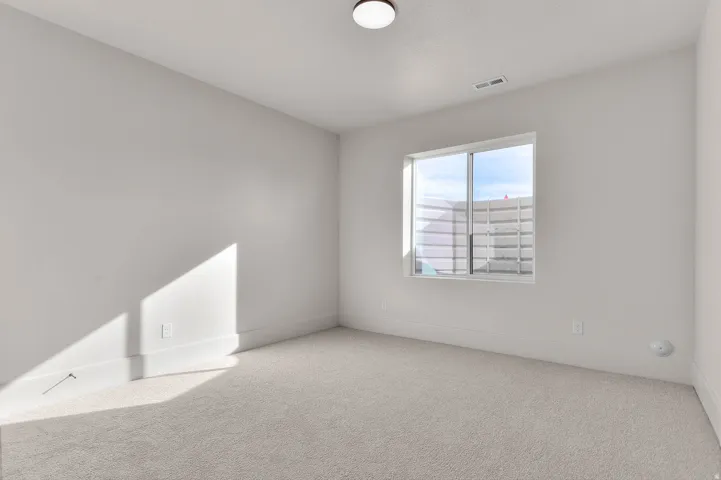 Unfurnished room with light carpet and baseboards