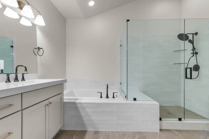 Bathroom with vanity, a stall shower, a bath, and recessed lighting