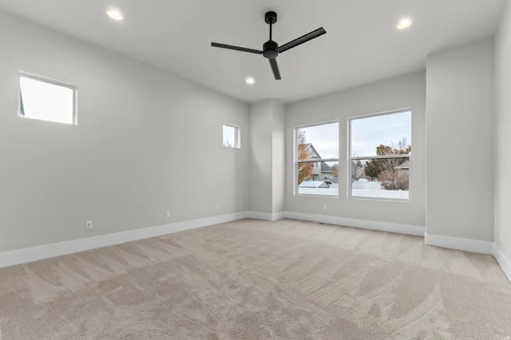 Unfurnished room featuring light carpet, recessed lighting, and a ceiling fan