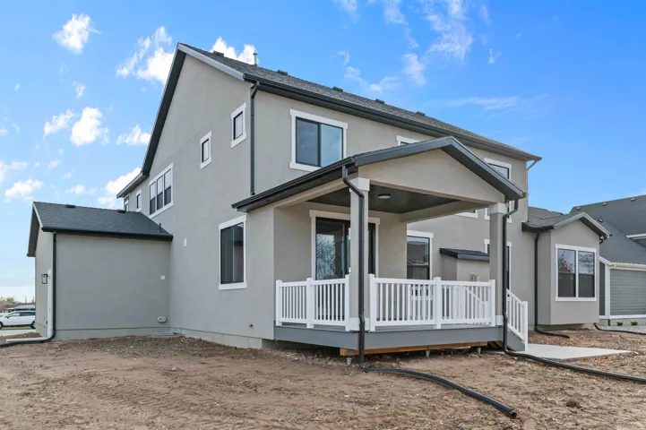 Back of house featuring a wooden deck and stucco siding
