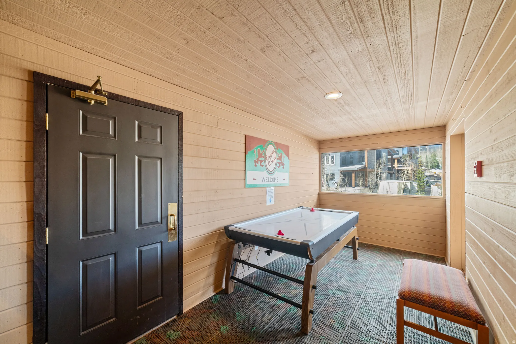 Playroom featuring wooden walls and wood ceiling