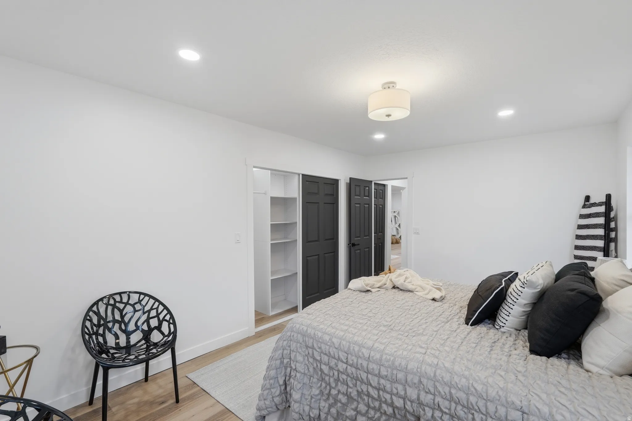 Bedroom with light wood finished floors and recessed lighting