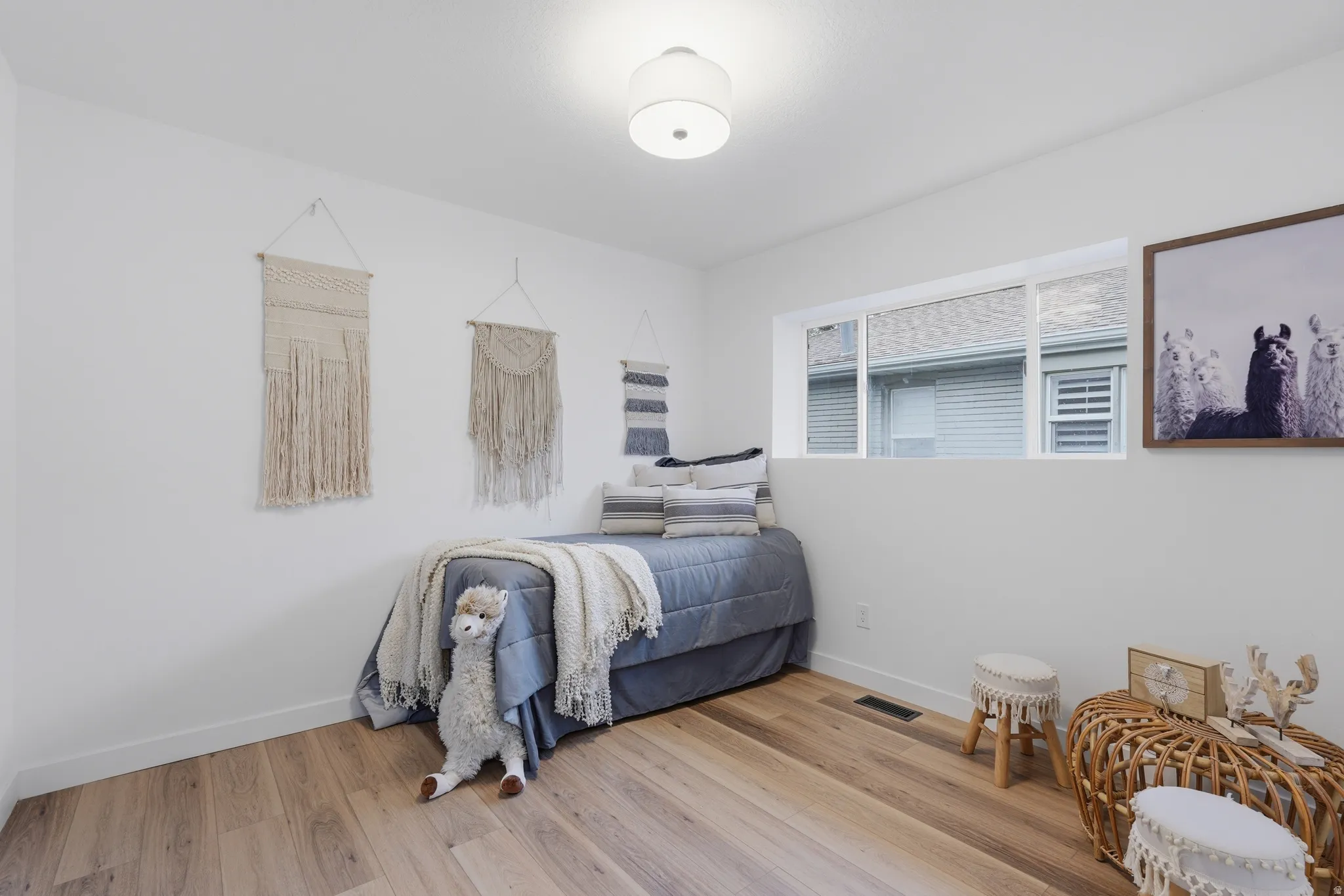 Bedroom with baseboards and light wood-style flooring
