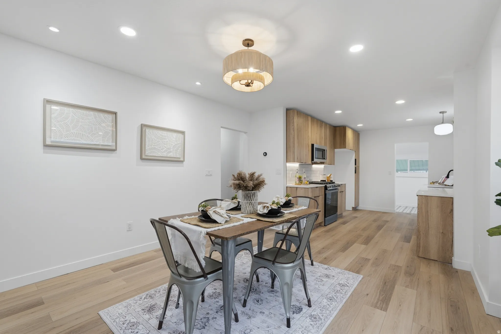 Dining area with light wood-style floors and recessed lighting
