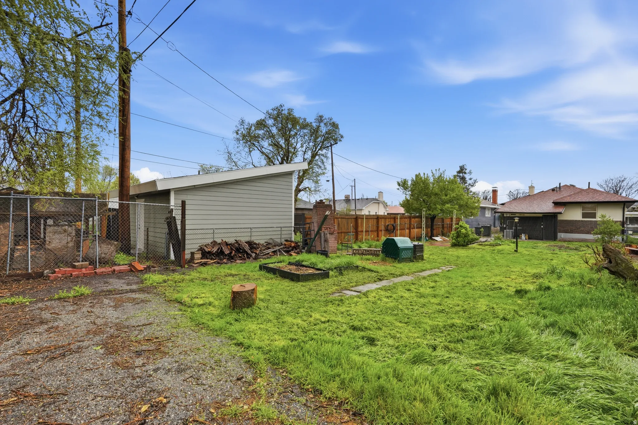 Fenced backyard featuring a vegetable garden