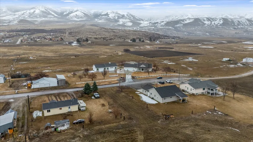 Aerial view of property's location featuring rural landscape and nearby suburban area