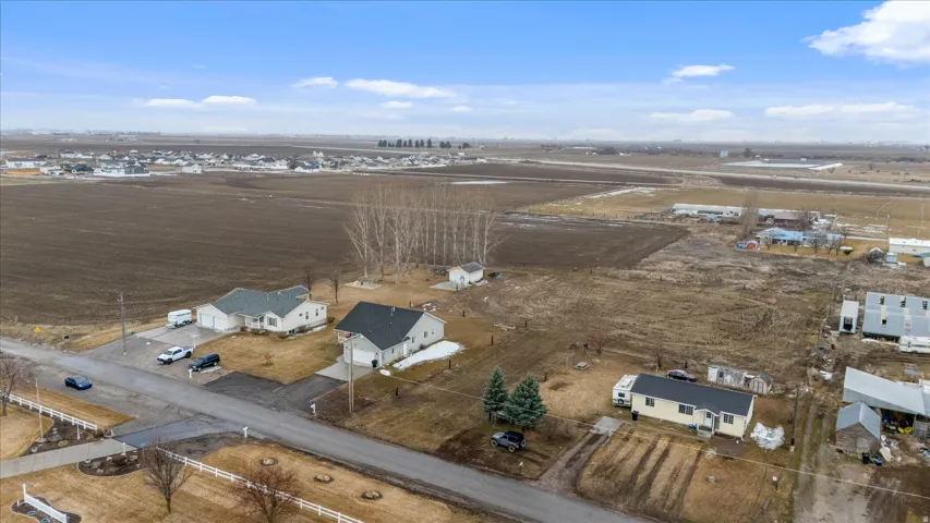 Aerial view of property's location featuring nearby suburban area and rural landscape