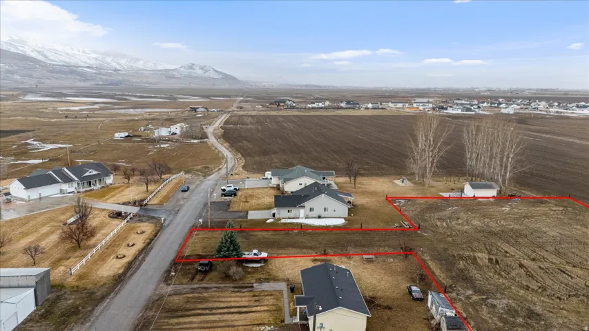 Overview of rural landscape featuring property boundaries highlighted and mountains