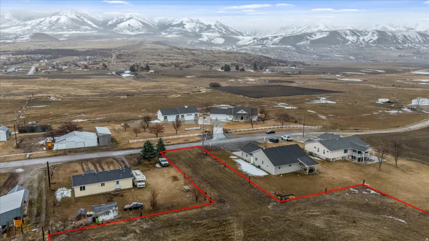 View of rural area with property boundaries highlighted, a mountain backdrop, and nearby suburban area