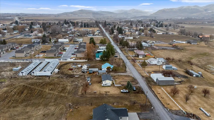 Aerial view of property's location featuring a mountain backdrop and nearby suburban area
