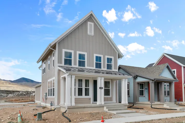 View of front of home featuring covered porch, a standing seam roof, and board and batten siding