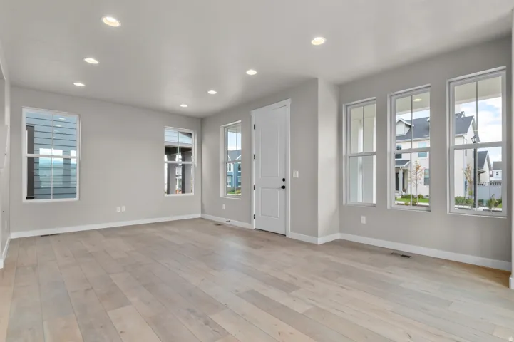 Entrance foyer with light wood-style flooring and recessed lighting