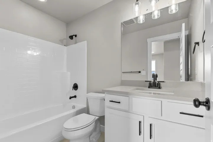 Bathroom featuring vanity, bathing tub / shower combination, and recessed lighting