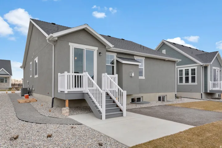 Rear view of property with stucco siding