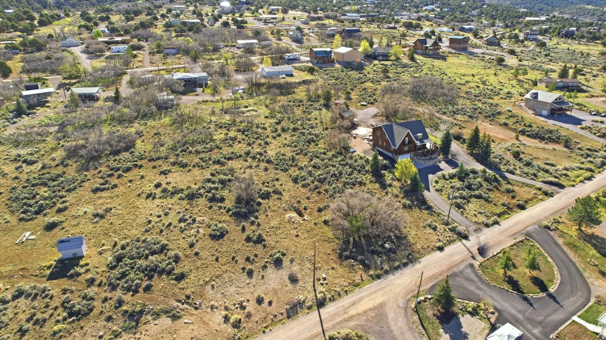 Expansive natural landscape featuring a prominent A-frame style home