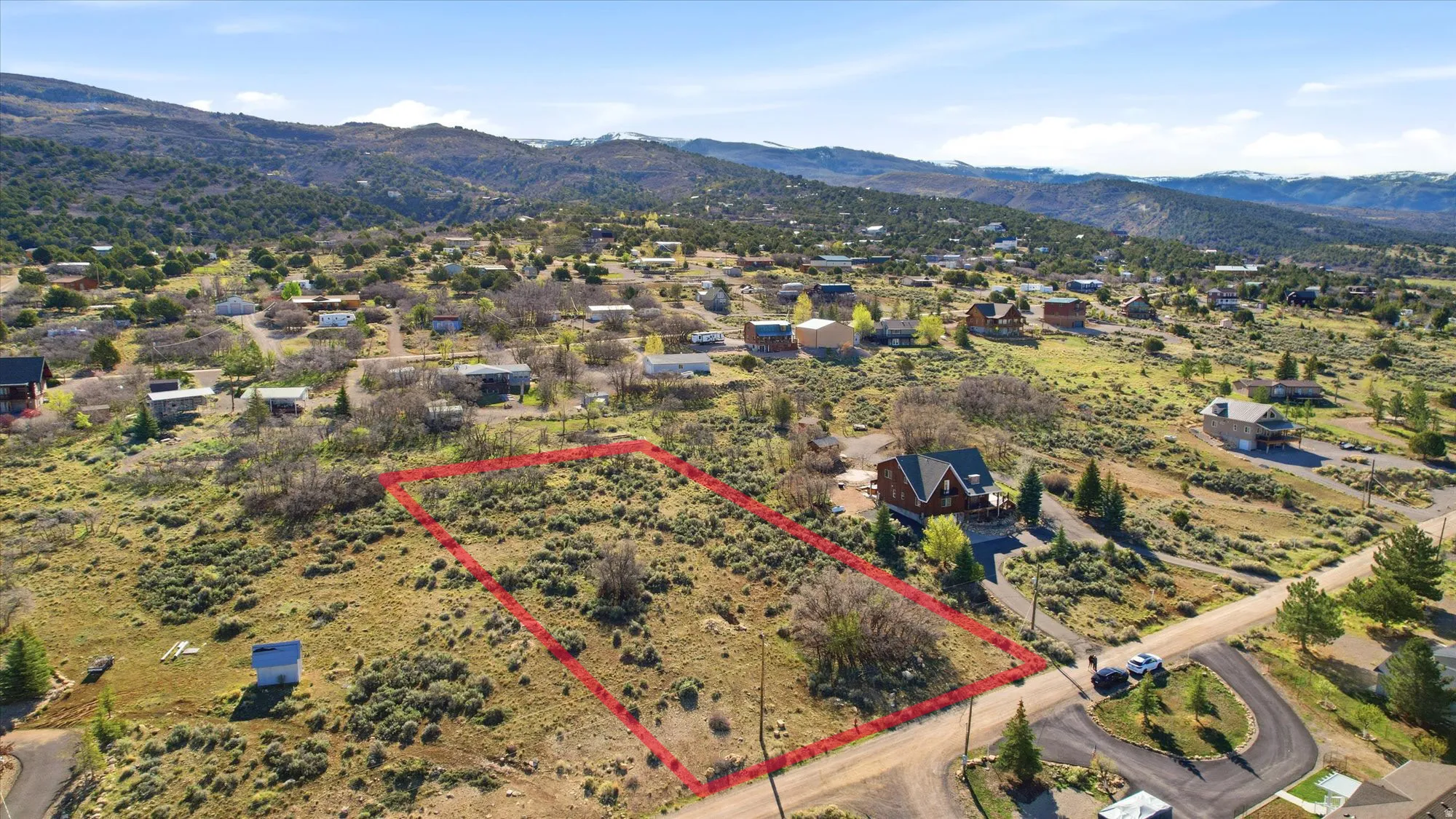 Expansive land parcel featuring natural shrubbery and an established mountain backdrop