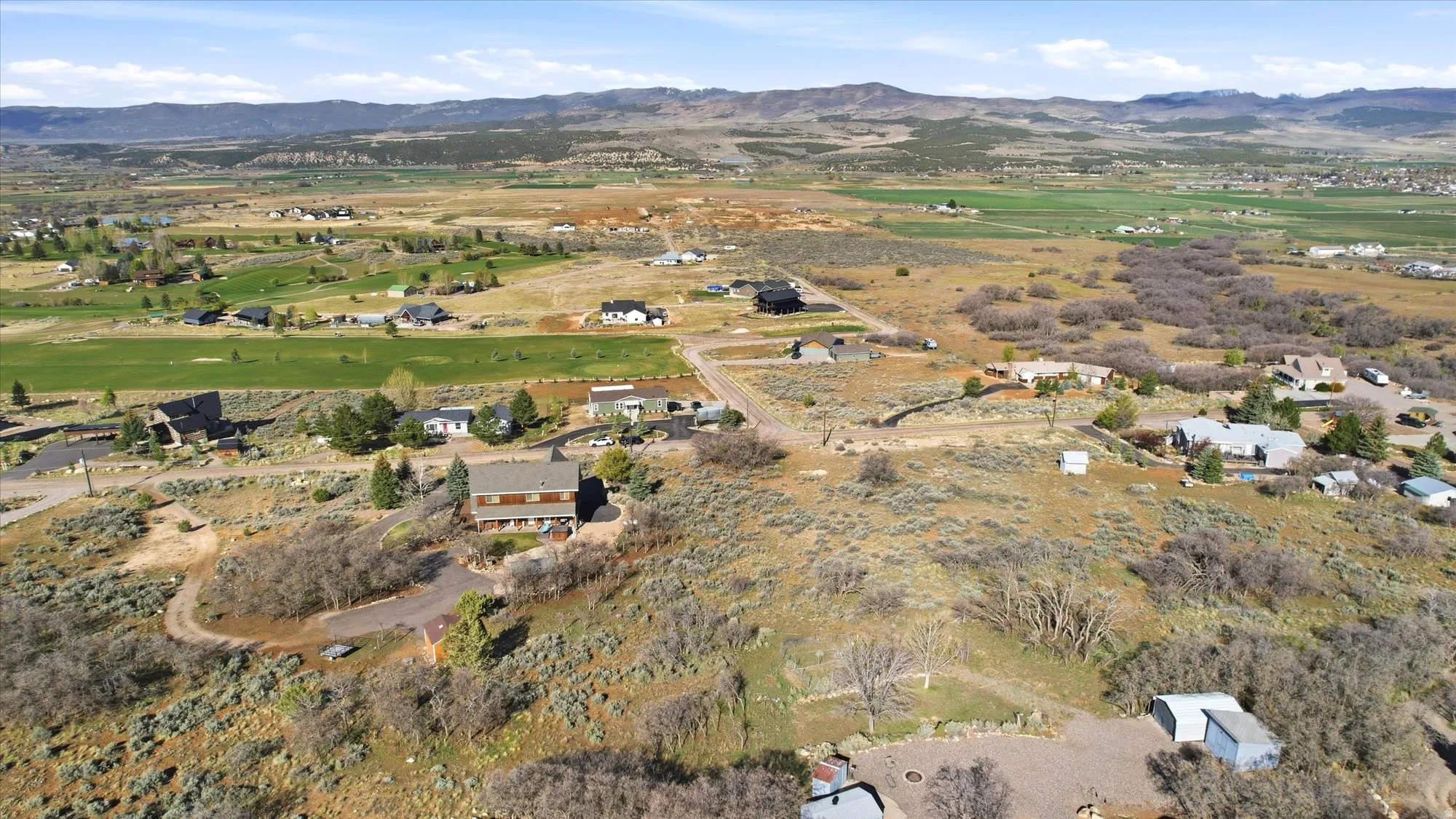 Expansive aerial perspective showcasing a rural landscape with scattered residential properties