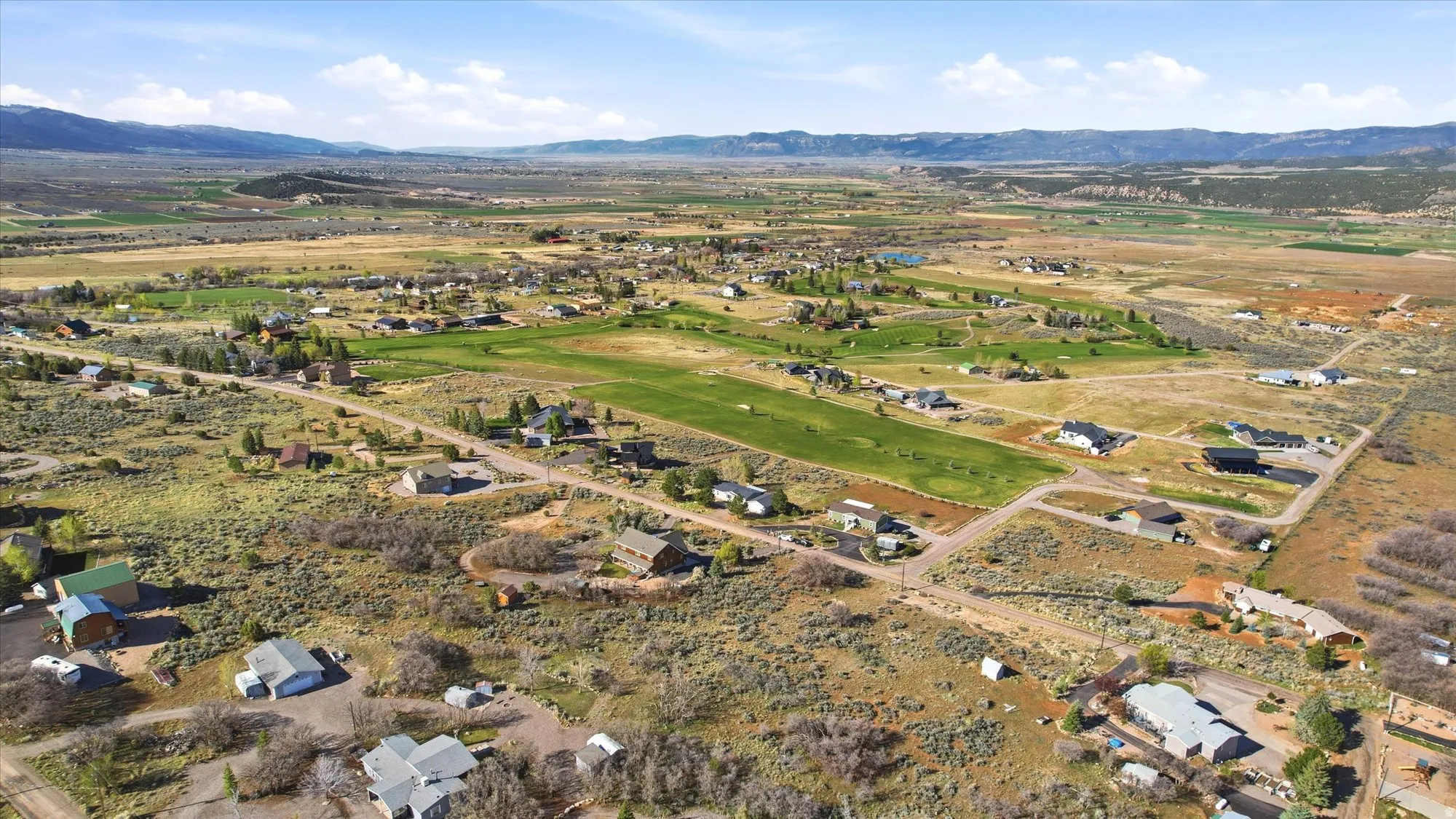 Expansive aerial perspective showcasing a residential development amidst a natural landscape